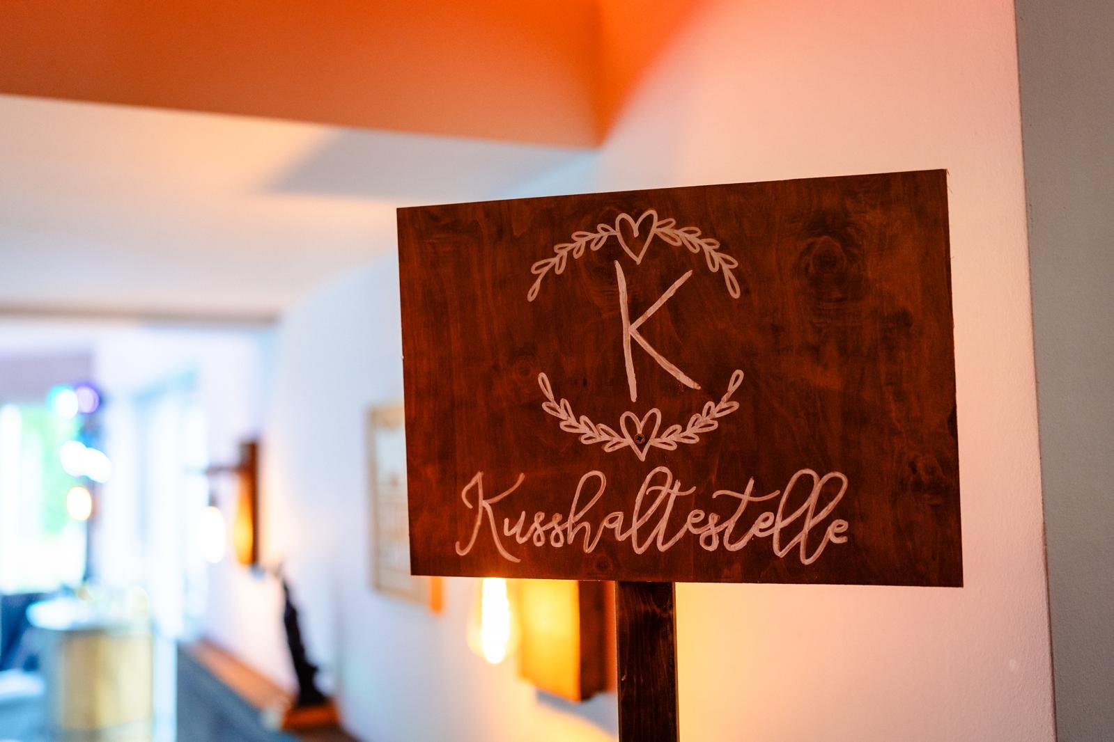 Kuss-Haltestelle Schild in einer geordneten und liebevoll vorbereiteten Hochzeitslocation
